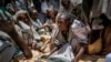 An Ethiopian woman argues with others over the allocation of yellow split peas after it was distributed by the Relief Society of Tigray in the town of Agula, in the Tigray region of northern Ethiopia, May 8, 2021.