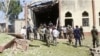 Soldiers stand guards outside St. Rita's Catholic church following a suicide bombing in Kaduna, Nigeria, October 28, 2012.