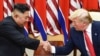 FILE - North Korea's leader Kim Jong Un (L) and U.S. President Donald Trump shake hands during a meeting on the south side of the Military Demarcation Line that divides North and South Korea, in the Demilitarized zone (DMZ) of Panmunjom, June 30, 2019. 