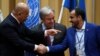 FILE - Head of Houthi delegation Mohammed Abdul-Salam, right, and Yemeni Foreign Minister Khaled al-Yaman, left, shake hands next to U.N. Secretary-General Antonio Guterres during the closing of the Yemen peace talks at the Johannesberg castle in Rimbo, Sweden, Dec. 13, 2018.