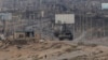 Seorang warga Palestina melarikan diri dari tank Israel di Jalur Gaza tengah pada Minggu, 9 Juni 2024. (Foto: AP)