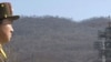 A crowd of media gather around a North Korean official in front of North Korea's Unha-3 rocket, slated for liftoff between April 12-16, at Sohae Satellite Station in Tongchang-ri, North Korea, April 8, 2012.