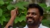 Anura Kumara Dissanayake, the presidential candidate from National People's Power, shows his ink-marked finger after casting his vote at a polling station, on the day of the presidential election, in Colombo, Sri Lanka, Sept. 21, 2024.