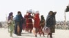 People from Afghanistan with their belongings cross into Pakistan at the 'Friendship Gate' crossing point, in the Pakistan-Afghanistan border town of Chaman, Pakistan, Sep. 7, 2021. 