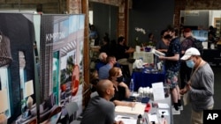 Empleadores atienden a buscadores de empleo durante una feria laboral en Los Ángeles, California, el 22 de septiembre de 2021. 