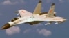 A Chinese J-11 fighter jet is seen flying near a U.S. Navy P-8 Poseidon about 215 km (135 miles) east of China's Hainan Island in this U.S. Department of Defense handout photo taken Aug. 19, 2014. 