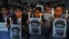 Indian school children hold photographs of Sarabjit Singh, an Indian spy on death row in Pakistan as they light candles and pray for his recovery in Amritsar, India, April 29, 2013.