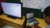 A Vietnamese officer prepares a flight route on a TV screen during a news conference about their mission to find missing Malaysia Airlines flight MH370 at Phu Quoc Airport on Phu Quoc Island, March 11, 2014.