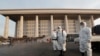 Workers wearing protective suits spray disinfectant as a precaution against the coronavirus at the National Assembly in Seoul, South Korea, Feb. 24, 2020. 