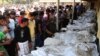 Bangladeshi people identify the bodies of their relatives died in a fire at a garment factory in the Savar neighborhood in Dhaka, Bangladesh, November 25, 2012.