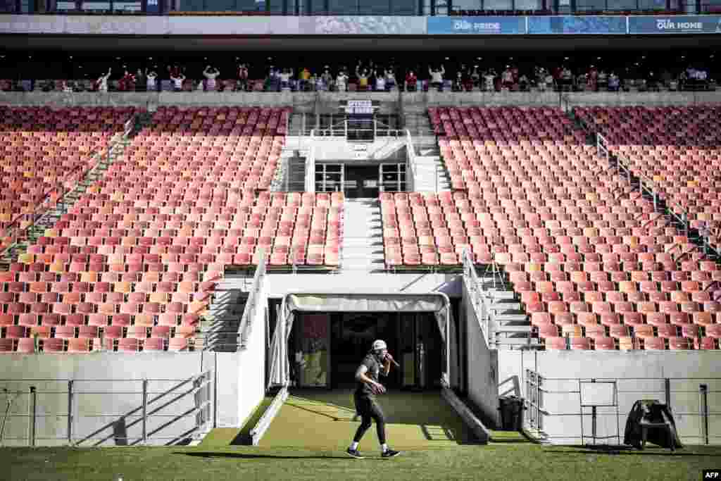 Fitness Instructor Loyolo Thandani conducts a fitness class with recovering COVID-19 coronavirus patients at the Nelson Mandela Bay Stadium government isolation and quarantine facility in Port Elizabeth, South Africa.