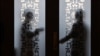 Security guards stand behind a glass door outside the Tibet hall in the Great Hall of the People during the National People's Congress in Beijing on March 6, 2024. Policymakers meeting in Beijing this week said China needs to increase employment and stabilize its property market.