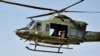 FILE - A Pakistani helicopter flies near the Baine Baba Ziarat mountain in Swat district, during a trip organized by the army May 22, 2009.