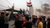 Protesters raise the Iraqi flag at the gate of the Iranian consulate building before storming and burning it in Basra, 340 miles (550 km) southeast of Baghdad, Iraq, Sept. 7, 2018. 