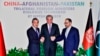 Pakistani Foreign Minister Shah Mahmood Qureshi, center, shakes hands with Afghan counterpart Salahuddin Rabbani, right, and Chinese counterpart Wang Yi in Islamabad, Pakistan, Sept, 7, 2019.