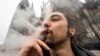 A man smokes cannabis in Cologne, Germany, on April 1, 2024. European police on April 11 arrested members of a gang they say defrauded victims in 35 countries in a medical cannabis Ponzi scheme.