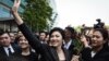 FILE - Former Thai prime minister Yingluck Shinawatra waves to supporters as she leaves the Supreme Court in Bangkok on Aug. 1, 2017. Thailand's Supreme Court on Monday cleared her of corruption in awarding a government contract during her time in office. 