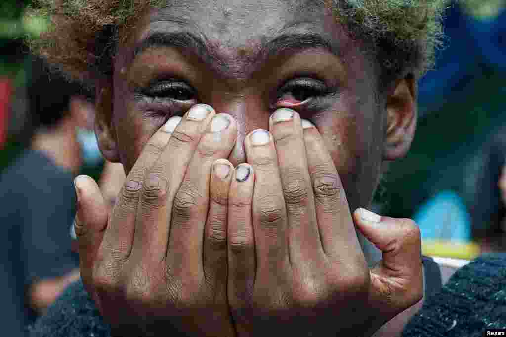 A woman cries as she watches people being detained on the Brooklyn Bridge just outside the &quot;City Hall Autonomous Zone&quot; in support of &quot;Black Lives Matter&quot; in the Manhattan Borough of New York City.