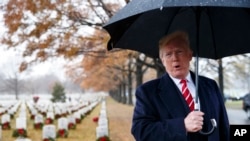 President Donald Trump speaks to media he visits Section 60 at Arlington National Cemetery in Arlington, Va., Dec. 15, 2018.