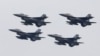 FILE - Pakistani Air Force F-16 fighter jets fly in formation during a military parade to mark Pakistan National Day, in Islamabad, Pakistan, March 23, 2019.