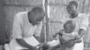 Chisomo Boxer examines Anthony’s feet to check for edema. Chisomo was trained by Save the Children to deliver primary health care in an isolated rural community in Malawi. Anthony’s mother Mercy is grateful that she does not have to walk 14 miles across r