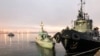 UKRAINE - Three ships of the Naval Forces of Ukraine artillery boats "Nikopol", "Berdyansk" and raid tug "Yani Kapu" (from left to right), towed to the city port, on November 26, 2018.