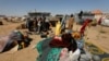New arrivals, who fled from violence, stand near their belongings at the Teachers' Village IDP camp in Maiduguri, Nigeria, Jan. 16, 2019.