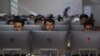 FILE - Independent Election Commission workers sit at computer terminals while election information from all over the country is gathered at a data center in Kabul, Oct. 2, 2019. 