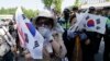 Supporters of former South Korean President Park Geun-hye weep to demand her release as a bus carrying her arrives at the Seoul Central District Court in Seoul, South Korea, May 25, 2017. 