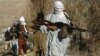FILE - Armed Taliban fighters are seen at an undisclosed location in Nangarhar province, Afghanistan, Dec.13, 2010.
