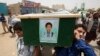 FILE - Yemeni men carry the coffin of a boy who was killed by a Saudi-led coalition airstrike, during a funeral in Saada, Yemen, Aug. 13, 2018.