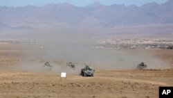 FILE - Afghan police special forces demonstrate their skills during an exercise in the Mohammad Agha district of Logar province, eastern of Kabul, Afghanistan, Nov. 30, 2017.