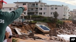 A swimming pool is dislodged and lays on a beach after storms undermined the pilings at Collaroy in Sydney, Monday, June 6, 2016.