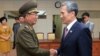 South Korean presidential security adviser Kim Kwan-jin, right, shakes hands with Hwang Pyong So, North Korea's top political officer for the Korean People's Army, after meeting at the border village of Panmunjom in Paju, South Korea, Aug. 25, 2015. 