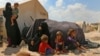 FILE - Displaced Syrians are seen at a camp near the border crossing with Turkey in the northern part of Syria's rebel-held Idlib province, Sept. 6, 2018.