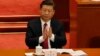 Chinese President Xi Jinping applauds China's Procurator-General Cao Jianming during a plenary session of China's National People's Congress, March 9, 2018, at the Great Hall of the People in Beijing.