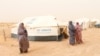 FILE - Libyan women displaced from the town of Tawergha are seen at a camp in the Garart al-Gatef, Libya, March 25, 2018. 