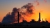 The Dave Johnson coal-fired power plant is silhouetted against the morning sun in Glenrock, Wyo., July 27, 2018. 