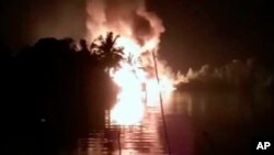 In this image made from video March 1, 2019, fire is seen from a pipeline explosion in Nembe, Nigeria.