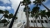 FILE - A police officer stands beside an entrance to the Alto Lee Adams Sr. U.S. Courthouse, Aug. 15, 2023, in Fort Pierce, Florida, where the case against Donald Trump for retaining classified documents after leaving office is being considered.