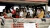 FILE - Sri Lankan migrants bound for Australia remain on board their boat docked at a port in Cilegon, Banten province, Indonesia, after they were intercepted by the Indonesian navy.