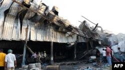 Firefighters work to extinguish a fire that broke out at an amusement park facility in Rajkot, in India's Gujarat state, on May 25, 2024.