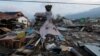 A teddy bear hangs next to earthquake and tsunami damaged property along the waterfront in Palu, Central Sulawesi, Indonesia, Oct. 10, 2018.
