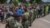 FILE - Demonstrators in Malawi rally in an anti-government protest as members of the country's security forces look on, in Lilongwe, Malawi, April 27, 2018. With elections nearing, pressure on rights activists is said to have increased in the country.