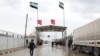 FILE - People cross from Turkey into northern Syria at the Bab al-Salam border crossing, March 13, 2020. 