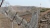 FILE - A view of the border fence outside the Kitton outpost on the border with Afghanistan in North Waziristan, Pakistan, Oct. 18, 2017. 