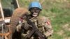 FILE - A United Nations peacekeeping soldier provides security during a food aid delivery by the United Nations Office for the Coordination of Humanitarian Affairs and World Food Program in the village of Makunzi Wali, Central African Republic, April 27, 2007.