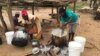 A family in Chachacha village in Chipinge prepares Zimbabwe’s popular, thick porridge called sadza made of corn meal and served with relish, March 2016. Most households eat sadza twice a day, at lunch and dinner. But as the country’s hunger worsens, the s
