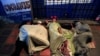 FILE - People sleep on makeshift beds on a street, where Venezuelan migrants gather to spend the night, in Maicao, Colombia, Feb. 15, 2018. 