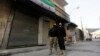 FILE - Free Syrian Army fighters look at a Syrian opposition flag in Aleppo's Bustan al-Basha district.